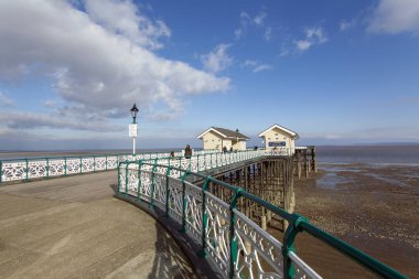 Penarth, UK: March 10, 2016: The Victorian era Penarth Pier in the Vale of Glamorgan was opened in 1894. It is still popular with tourist and locals.  clipart