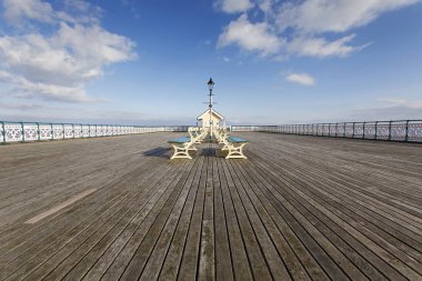 Penarth, UK: March 10, 2016: The Victorian era Penarth Pier in the Vale of Glamorgan was opened in 1894. It is still popular with tourist and locals.  clipart