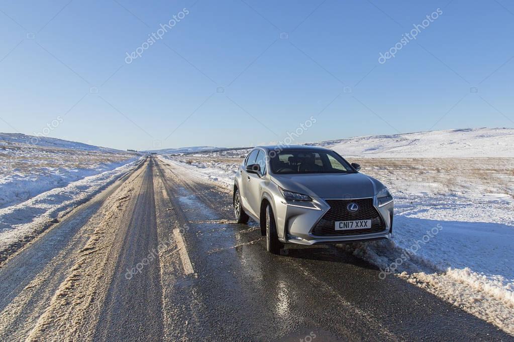Brecon Beacons, UK: December 11, 2017: A Lexus NX 300h F-Sport crossover hybrid car on the road side in snow and icy conditions.