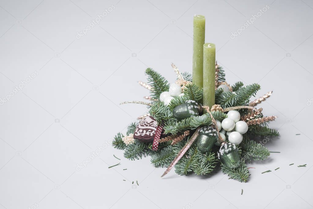 close-up of green fir tree branches with Christmas decoration and candles 