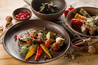 ızgara ve doldurulmuş sebze, Erik ve nar taneleri ahşap masa üzerinde kapat