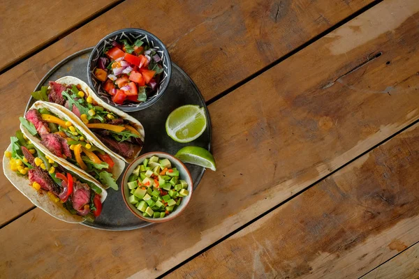 Köstliche Tacos Mit Limettenscheiben Und Geschnittenem Gemüse Schüsseln Auf Holzhintergrund — Stockfoto