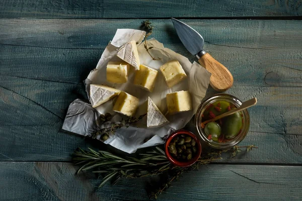 Deitado Com Queijo Brie Faca Ervas Frascos Com Azeitonas Capperi — Fotografia de Stock