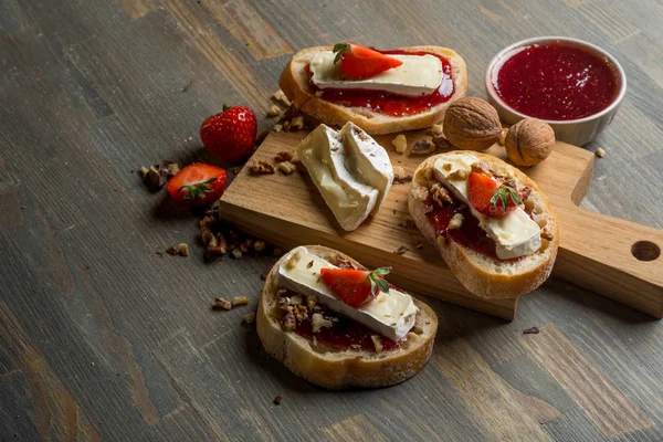 Delicious Sandwiches Strawberries Nuts Cheese Wooden Cutting Board Top View — Stock Fotó