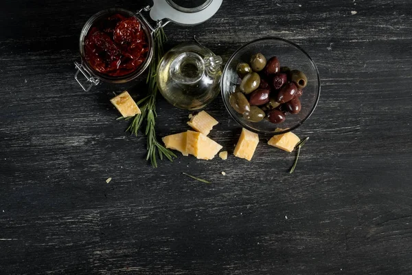 Salami Olives Cheese Olive Oil Black Wooden Table Copy Space — Stock Photo, Image