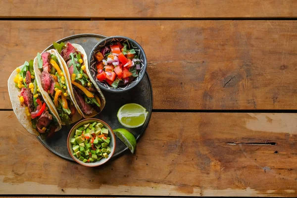 Köstliche Tacos Mit Limettenscheiben Und Geschnittenem Gemüse Schüsseln Auf Holzhintergrund — Stockfoto
