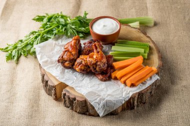 Buffalo kanatlar sebze dilimleri ile rustik arka plan üzerinde tavuk