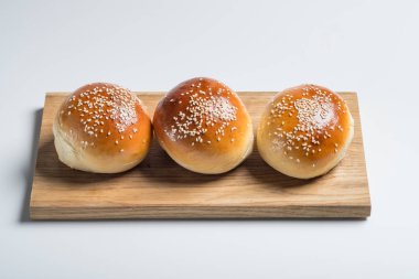 Burger ekmek buns ahşap masa beyaz izole arka planda, üstten görünüm 