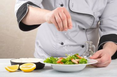 Beyaz ahşap masa üzerinde yemek salata karides, sebze ve zeytinyağı ile Şef 