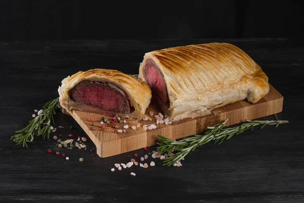 Beef wellington on cutting board, close up