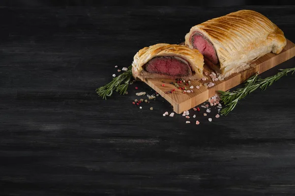 Beef wellington on wooden board with copy space