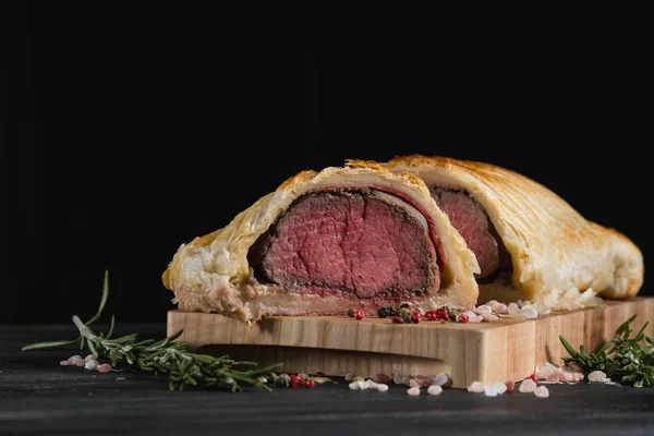 Beef wellington on wooden board with copy space