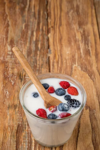 Glas Milkshake Med Bär Och Träsked Träbord Ovanifrån — Stockfoto