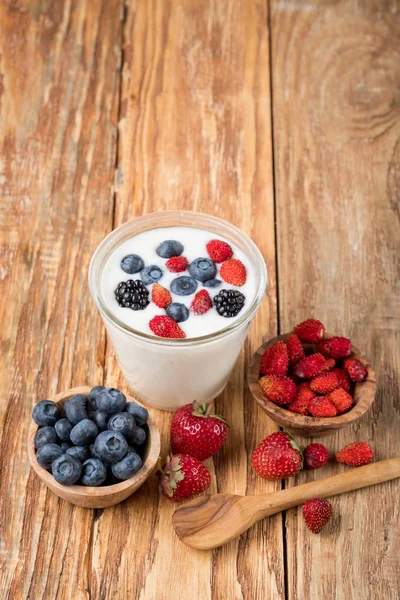 Yogurt Glass Berries Bowls Strawberries Blueberries Wooden Spoon Table Copy — Stock Photo, Image