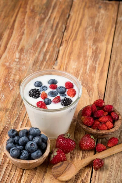 Yogurt Glass Berries Bowls Strawberries Blueberries Wooden Spoon Table Copy — Stock Photo, Image