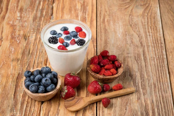 Yogurt Glass Berries Bowls Strawberries Blueberries Wooden Spoon Table Copy — Stock Photo, Image