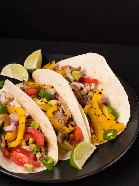 Tacos with ingredients on wooden background. Mexican traditional food. Flat top view, overhead.