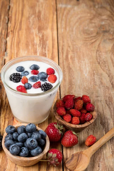 Yogurt Glass Berries Bowls Strawberries Blueberries Wooden Spoon Table Copy — Stock Photo, Image