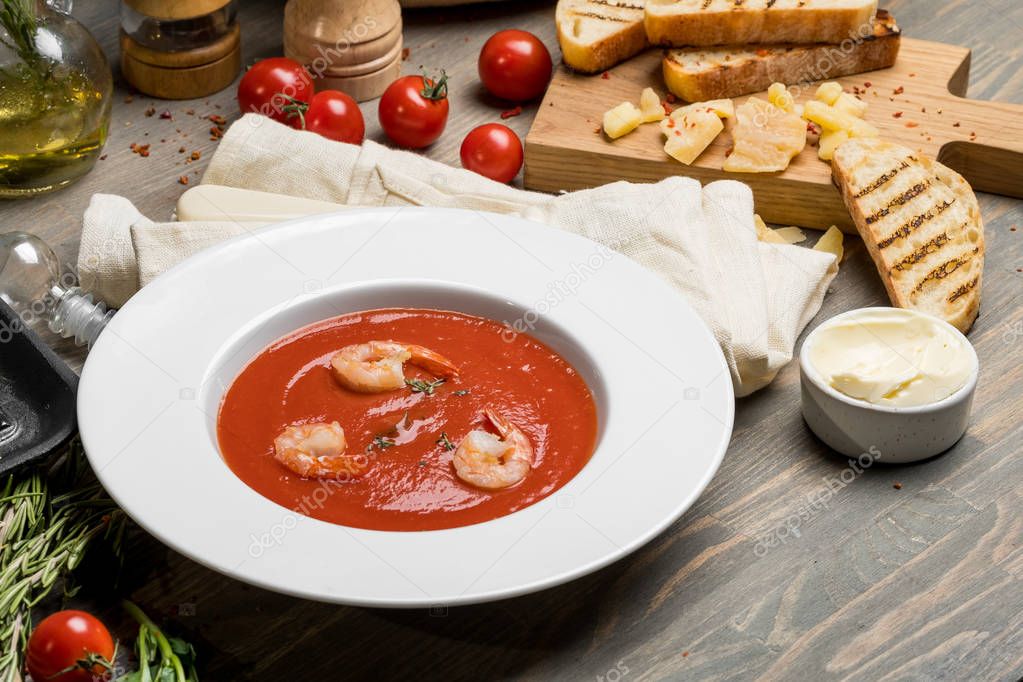 tomato soup with herbs and prawns
