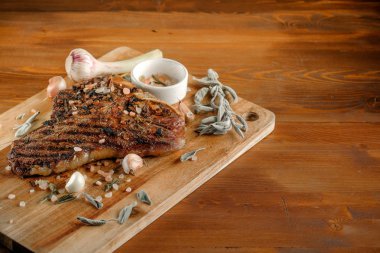 baharat, sarımsak ve ahşap tahta zemin üzerine kuru adaçayı ile ızgara et   