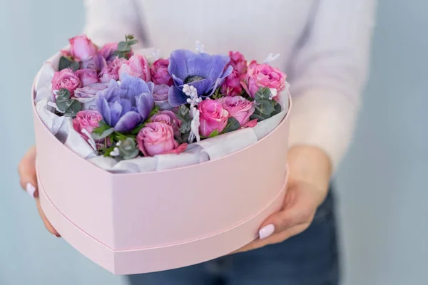 Närbild Kvinnliga Händer Som Håller Rosa Hjärtformade Presentbox Med Blommor — Stockfoto