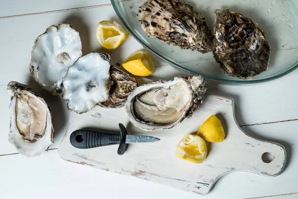 Fresh Raw Oysters Lemon Slices Wooden Board Knife Bowl White — Free Stock Photo