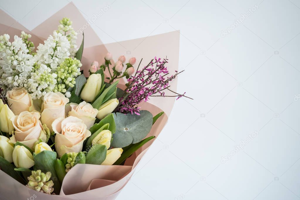 close-up of beautiful bouquet of spring tulips and roses flowers