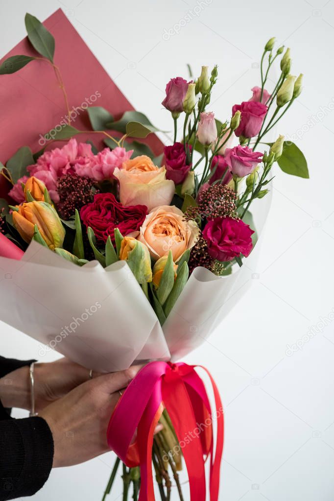 Woman holding stylish bouquet of red flowers