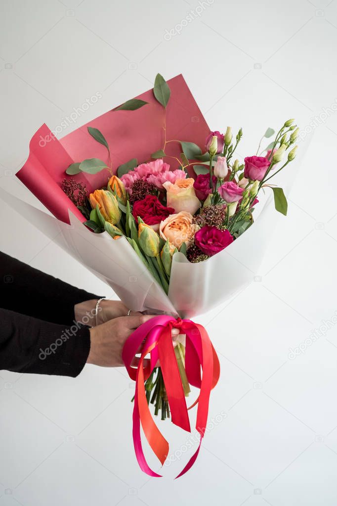 Woman holding stylish bouquet of red flowers