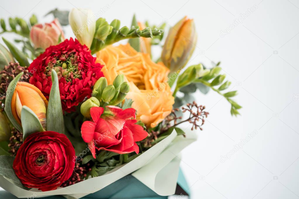 Bright stylish bouquet of red and orange flowers