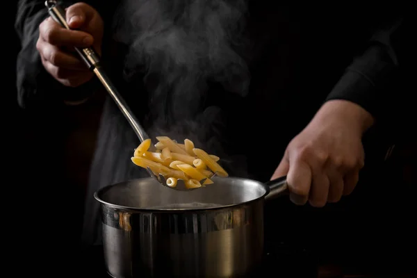 Close Photo Male Preparing Tasty Pasta Black Background — Stock Photo, Image