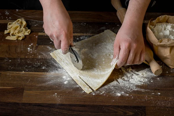 Close Photo Male Holding Knife Cut Dough Tasty Pasta Wooden — Stock Photo, Image