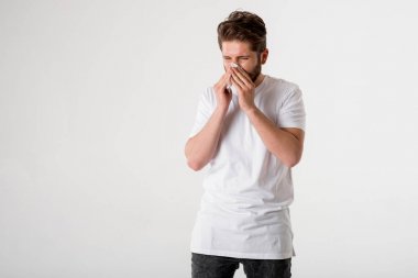 portrait of young sick man in white shirt with Cold or allergy on grey background clipart