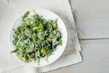 taze yeşil salata roka ve ıspanak masada beyaz plaka ile yakın çekim fotoğraf 