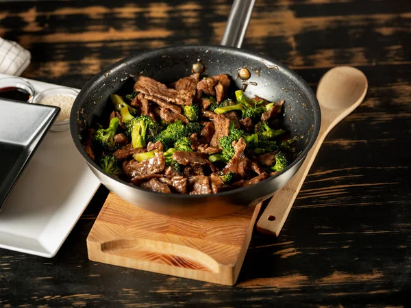 Beef with broccoli vegetables cooking roasting in steel pan.