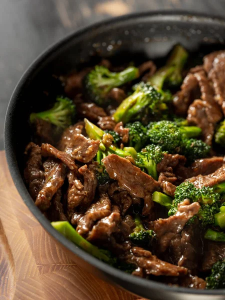 Beef with broccoli vegetables cooking roasting in steel pan.