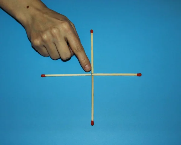 hand fingers take rearrange connects Wooden matches solve puzzle
