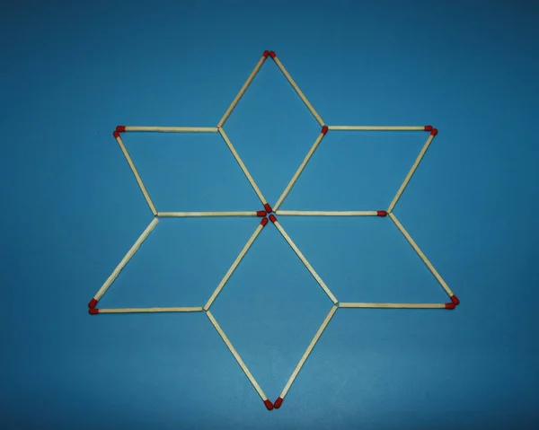 Wooden matchstick logic puzzle task geometric shape star