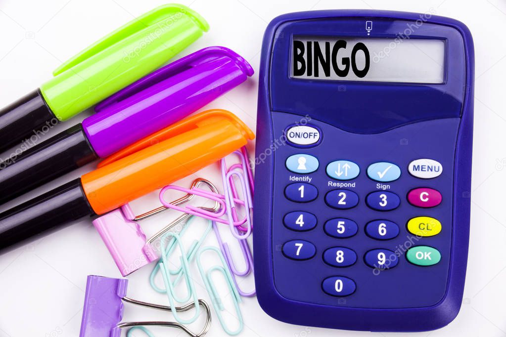Writing word Bingo text in the office with surroundings such as marker, pen writing on calculator. Business concept for Lettering Gambling to Win Price Success white background with space