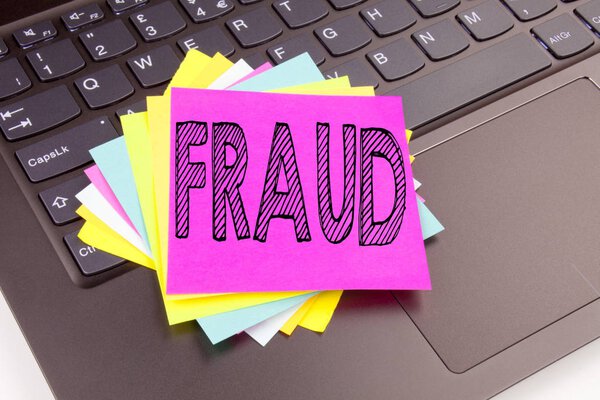 Writing Fraud text made in the office close-up on laptop computer keyboard. Business concept for Criminal hacker security prevention Workshop on the black background with copy space