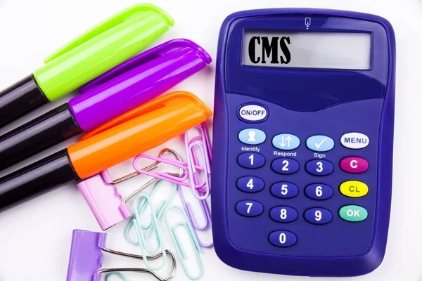 Escrevendo texto CMS palavra no escritório com arredores, como marcador, caneta escrita na calculadora. Conceito de negócio para CMS WWW fundo branco com espaço de cópia — Fotografia de Stock