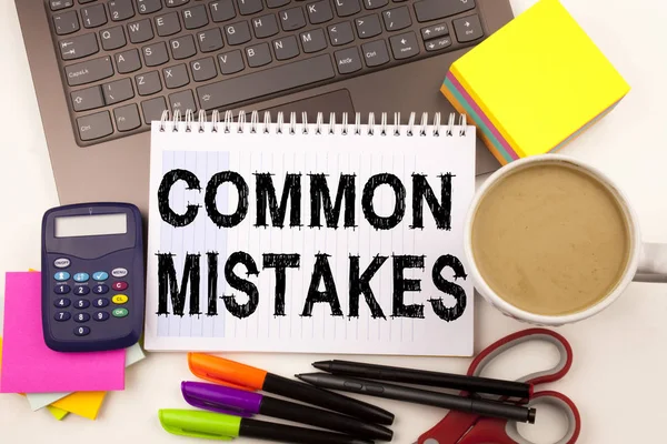 Word writing Common Mistakes in the office with surroundings such as laptop marker pen stationery coffee Business concept for Common Decision Mistakes Workshop background with copy space — Stock Photo, Image
