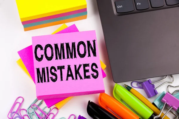 Writing showing Common Mistakes made in the office with surroundings such as laptop, marker, pen. Business concept for Common Decision Mistakes Workshop white background with copy space — Stock Photo, Image