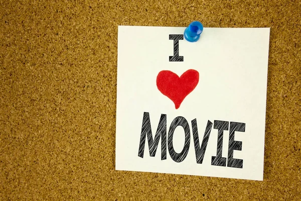 Hand writing text caption inspiration showing I Love Movie concept meaning Entertainment Movie Film Loving written on sticky note, reminder isolated background with copy space