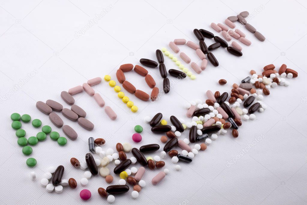 Hand writing text caption inspiration Medical care concept written with pills drugs capsule word Antioxidant On white isolated background with copy space