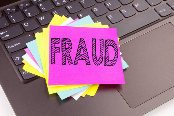 Writing Fraud text made in the office close-up on laptop computer keyboard. Business concept for Fraud Crime Business Scam Workshop on the black background with copy space