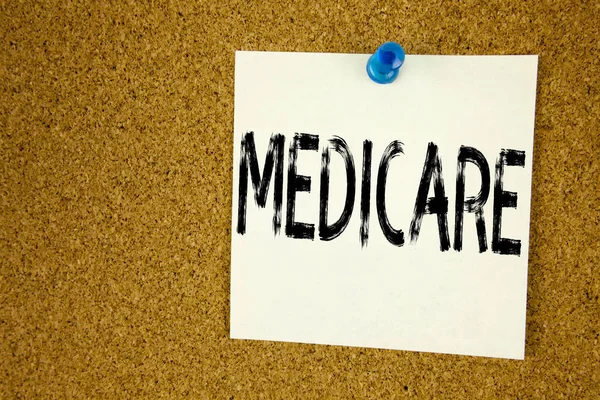 Conceptual hand writing text caption inspiration showing Medicare. Business concept for  Comprehensive Medical Insurance Health Plan written on sticky note, reminder cork background with copy space — Stock Photo, Image