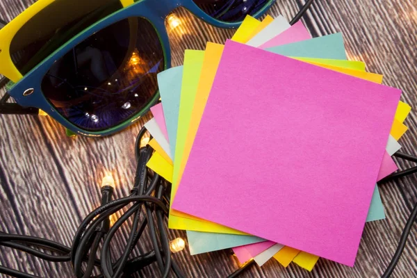 Yellow and blue sticky note with empty space for a text on wooden background. — Stock Photo, Image