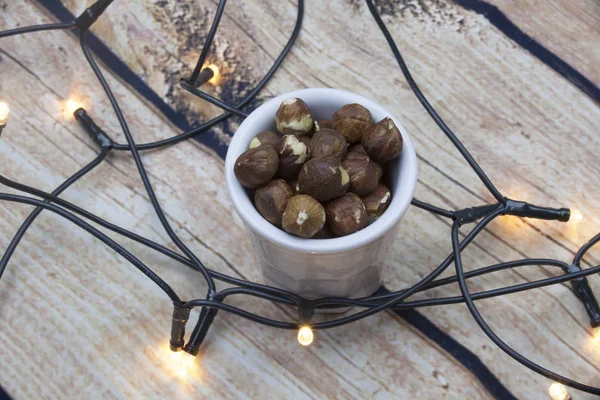 Peeled Hazelnuts Bowl Textured Wooden Background Top View Lights — Stock Photo, Image