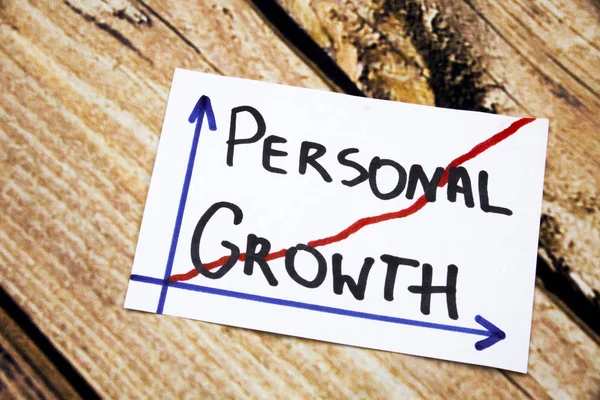 Personal growth - handwriting in a black ink on wooden background concept meaning personal development